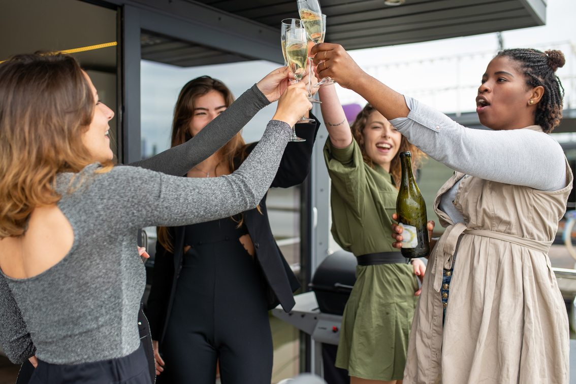 Women Holding Wine Glasses Toasting