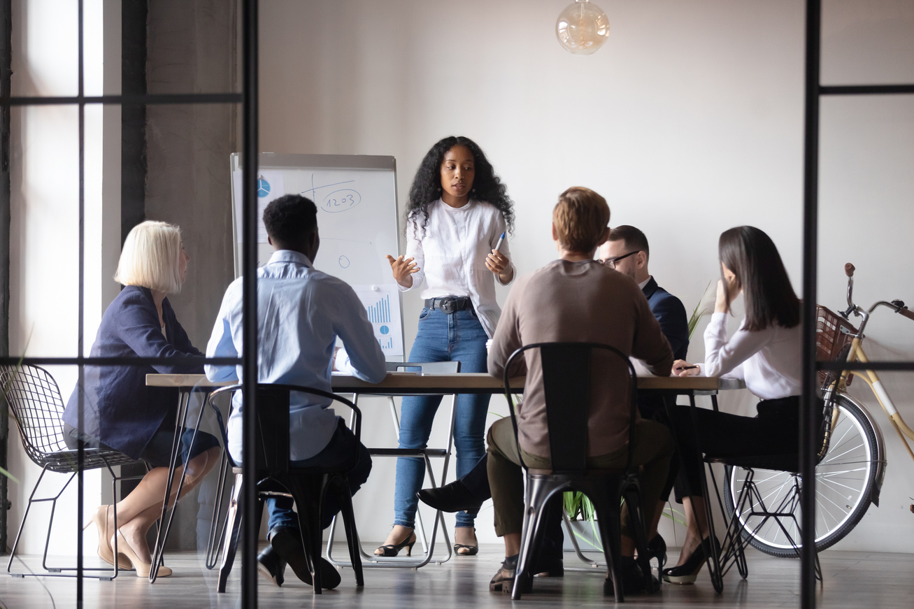 Confident african businesswoman presenter give corporate whiteboard presentation